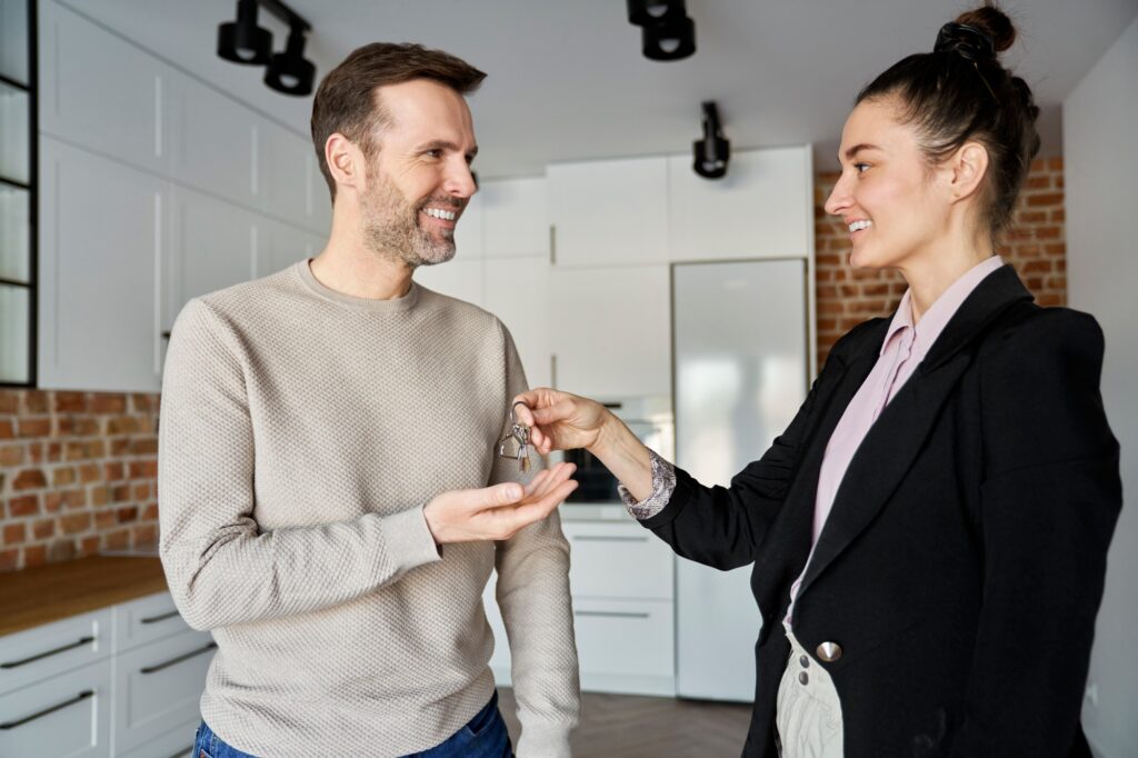 Estate agent hands the keys to the man