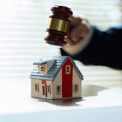 lawyer mediating in a property dispute. Auctioneer knocking down a property sale. Real estate sale